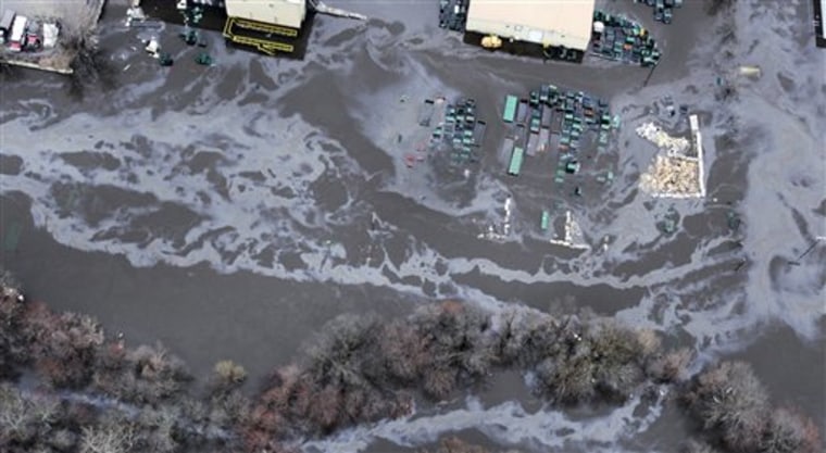Floodwaters from the Pawtuxet River picked up oil and other contaminants in this industrial area of Warwick, R.I., on Wednesday.